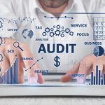 human typing computer keyboard audit business charts with words