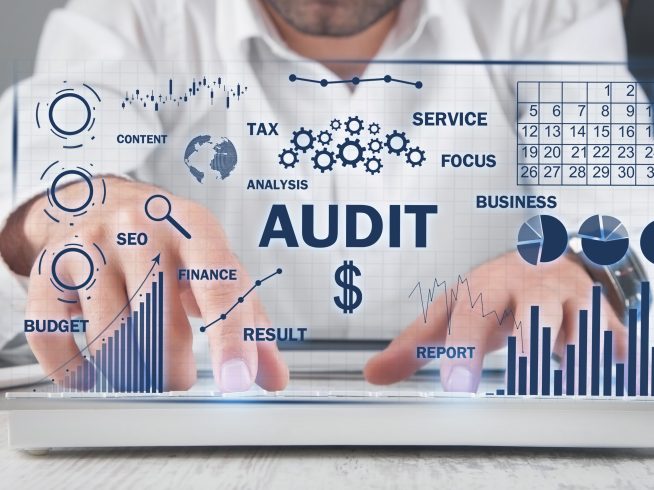 human typing computer keyboard audit business charts with words